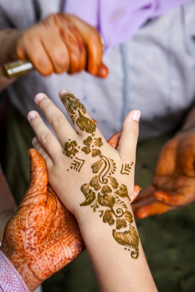 The Art and Tradition of Mehndi Design: A Journey of Beauty and Culture 6 high angle close up of henna tattoos being put on 2023 11 27 05 03 44 utc