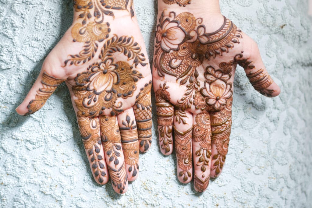 The Art and Tradition of Mehndi Design: A Journey of Beauty and Culture 9 women applying henna on hand top view 2023 11 27 05 01 14 utc 1